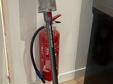 un aspirateur posé par terre à côté d'un réfrigérateur