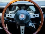 a steering wheel and dashboard of a car with wood trims