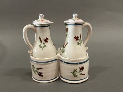 two white and blue vases with red flowers on them
