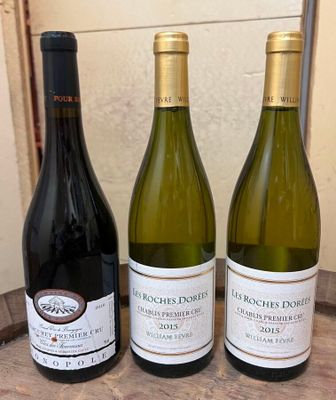 three bottles of wine sitting on a table next to each other