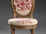 a close up of a chair with a floral design on it