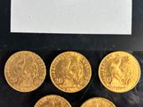 six gold sovereigns in a display case with a price tag