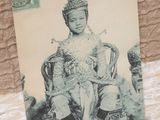 an old photo of a young boy sitting on a chair