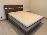 un lit sur lequel est posé un matelas dans une pièce