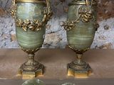 two vases sitting on top of a table next to each other