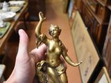 a person holding a statue in their hand in a room