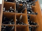 many spoons in a wooden box on a table