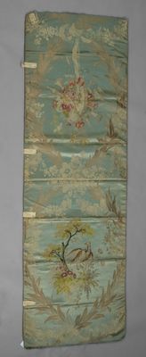an image of a wall hanging with a bird and flowers on it
