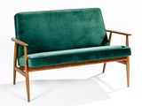 an image of a green couch sitting on top of a white floor