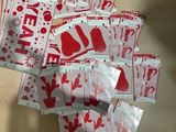 a pile of red and white christmas stickers on a table