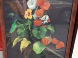 two framed pictures of flowers on the ground