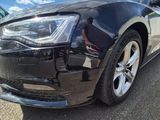 an image of a black car parked in a parking lot