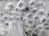 many rolls of plastic wrap on a shelf in a store