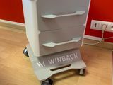 an image of a white cart with drawers on wheels