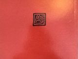 a red box with a black logo on it sitting on top of a table
