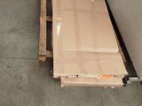 a box that is sitting on the floor next to a refrigerator