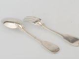 two silver spoons and a fork on a white surface