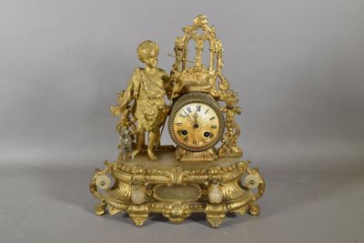 a gold clock that is sitting on top of a table