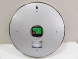 an image of a clock with a green button on it