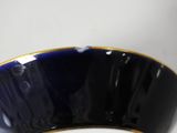 an image of a close up of a blue bowl with a gold rim
