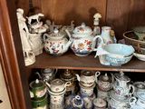 a wooden cabinet with many different types of china on it