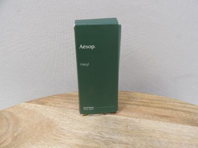 an image of a bottle of aesopp on a wooden table
