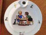 a plate with a picture of a boy and a girl sitting at a table