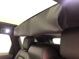 a view of the back seats of a car with the sun shining through the window
