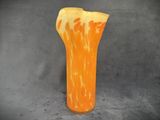 an orange and white vase that is on a table