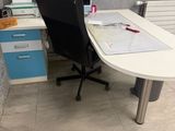 a desk with a chair and a computer on it