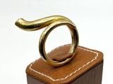 a gold ring sitting on top of a wooden block