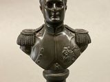 bronze bust of a man wearing a helmet with a chain around his neck