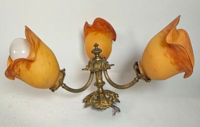 two lamps that are on the wall next to each other