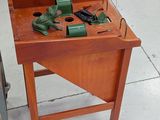 a small wooden table with tools on it in a room