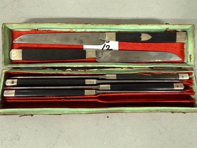 four knives in a box with a red cloth