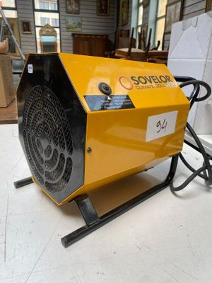 an electric heater sitting on top of a table in a room