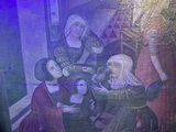 a painting on the wall of a building that has a picture of a group of people