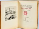 an open book with a drawing of a rose on it