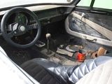 dashboard of a car with a can of soda in the middle of it