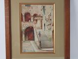framed picture of a picture of a building with a staircase going up it