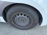 a close up of a tire on a white car
