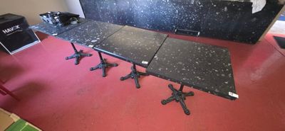 a black table with four chairs in a room