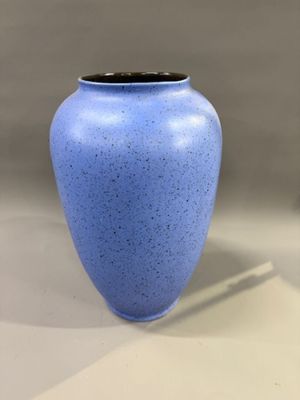 a blue vase that is sitting on a table