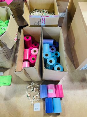 several boxes of assorted colored paper are sitting on the floor