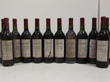 six bottles of wine are lined up in a row on a table