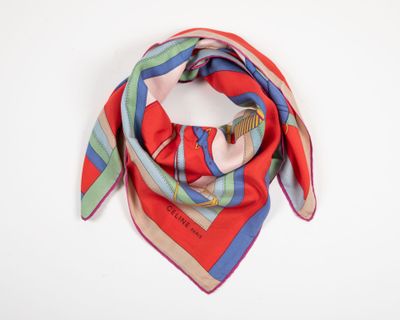 a close up of a red and blue scarf on a white surface