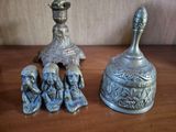 two silver bells sitting on top of a wooden table next to each other