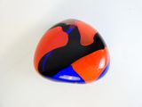 an orange and blue object on a white surface