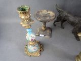a statue of a dog standing next to a table with a vase on it