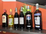 many bottles of wine sitting on a shelf next to each other